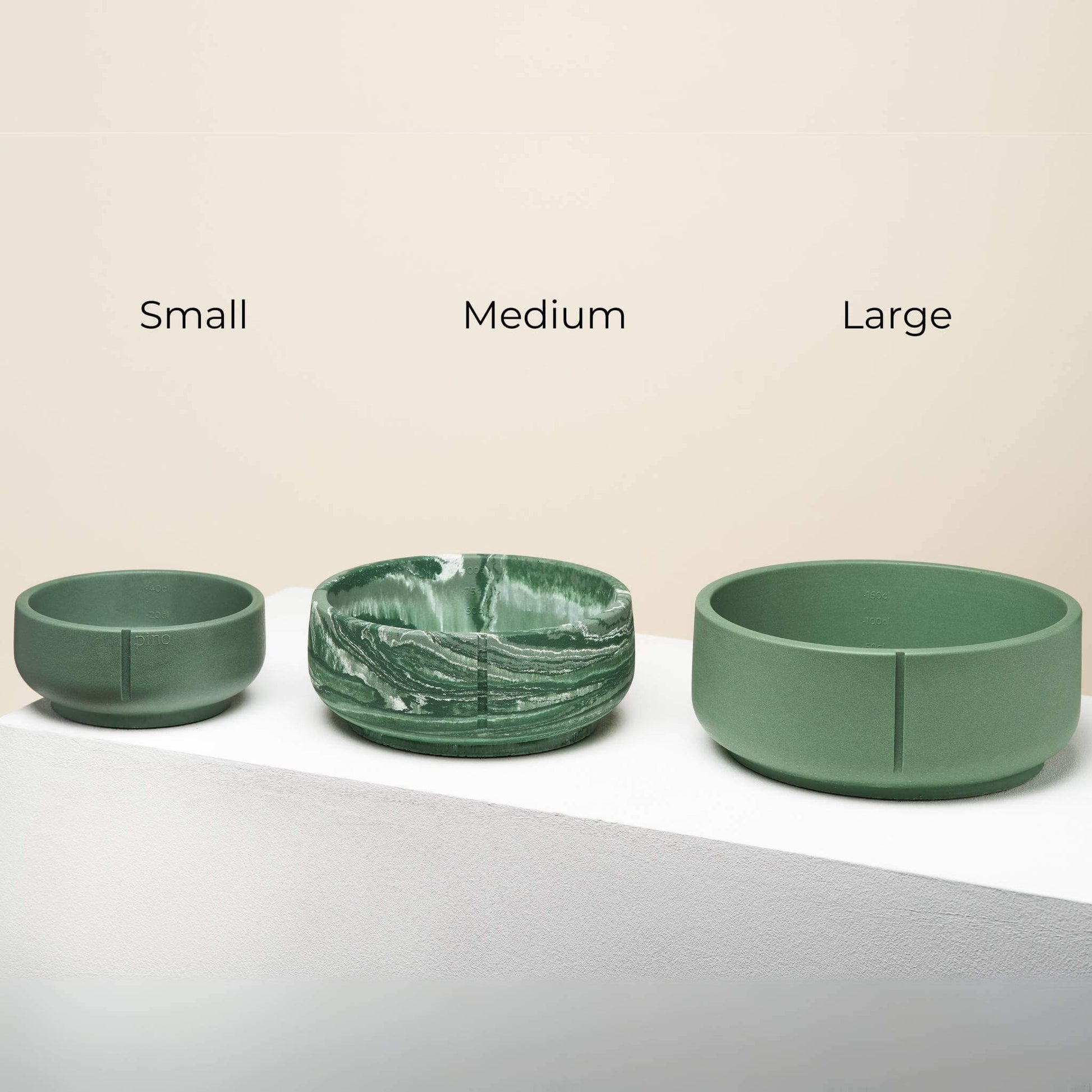 Three duck green bowls next to each other in three different sizes