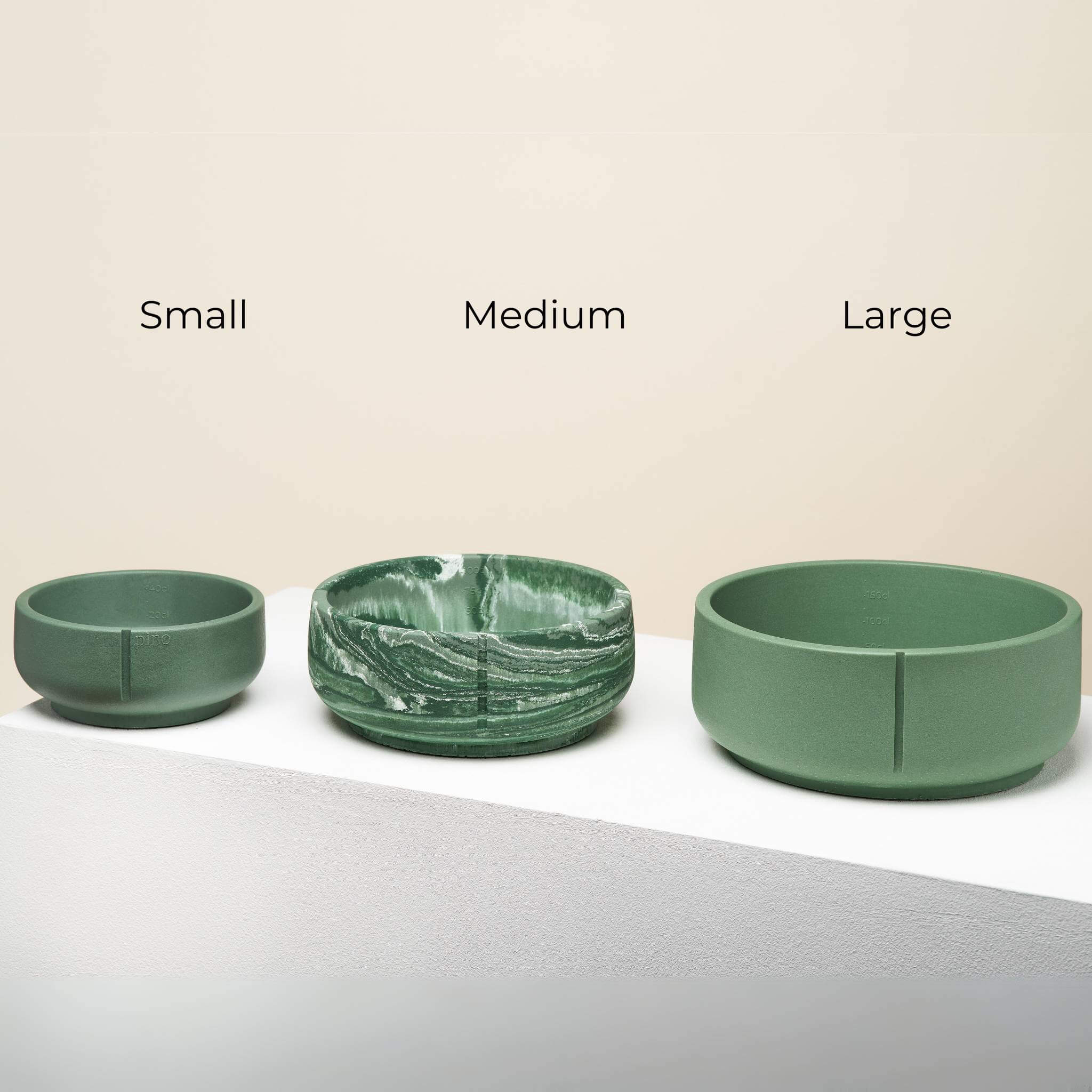 Three duck green bowls next to each other in three different sizes